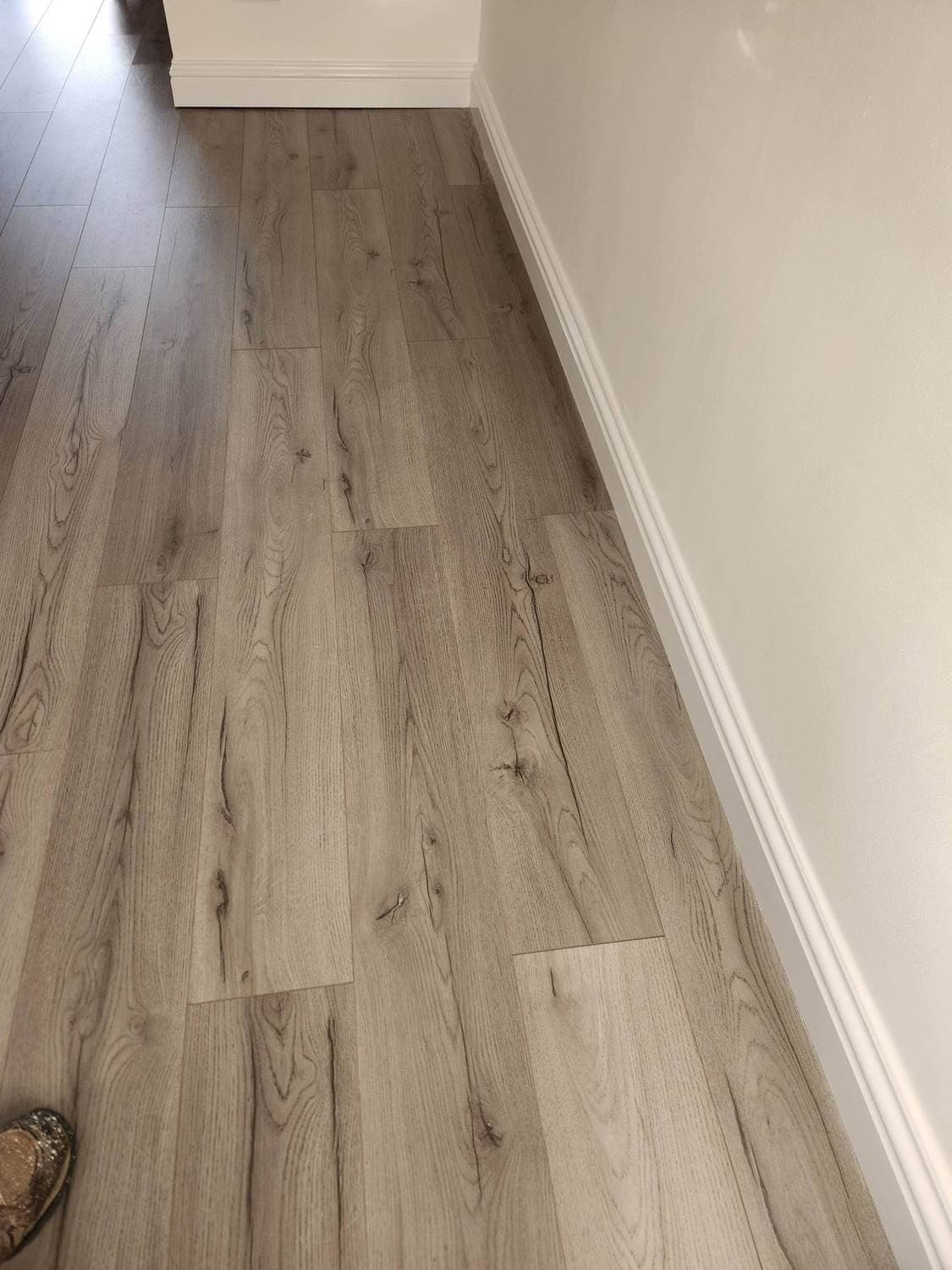 New wood-effect flooring with crisp white skirting board